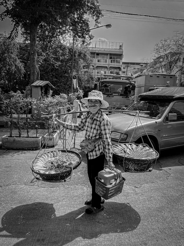 Thai woman carrying fresh fish