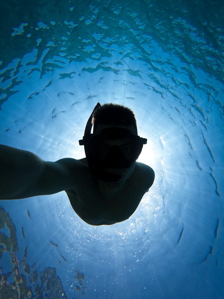 Underwater selfie with backlit sunlight