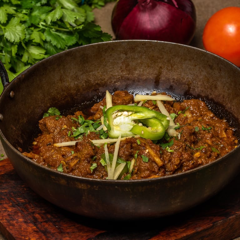 Lamb karahi dish with corander, red onion and tomato
