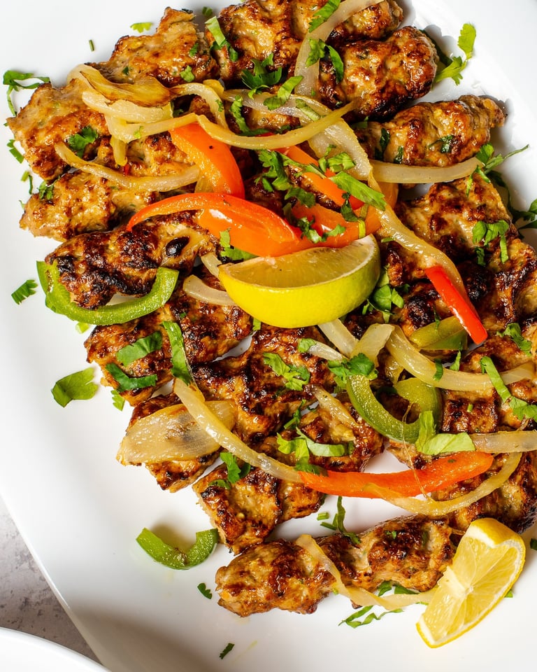 Kebabs on plate with vegetables