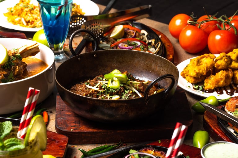 Lamb karahi on table with other dishes