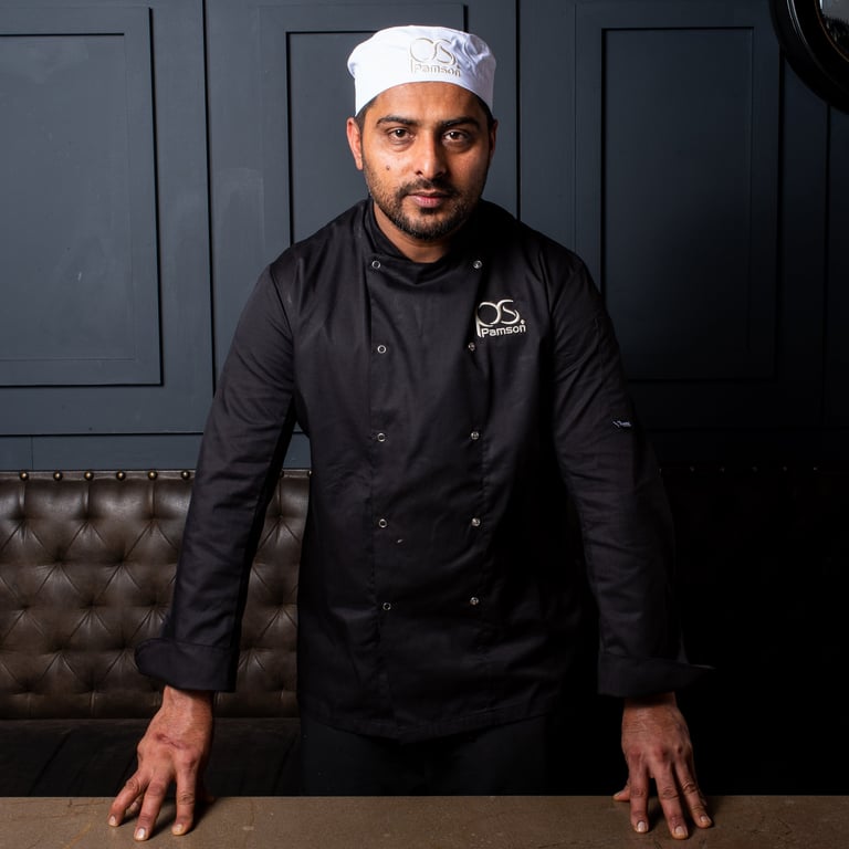 Chef headshot leaning on table