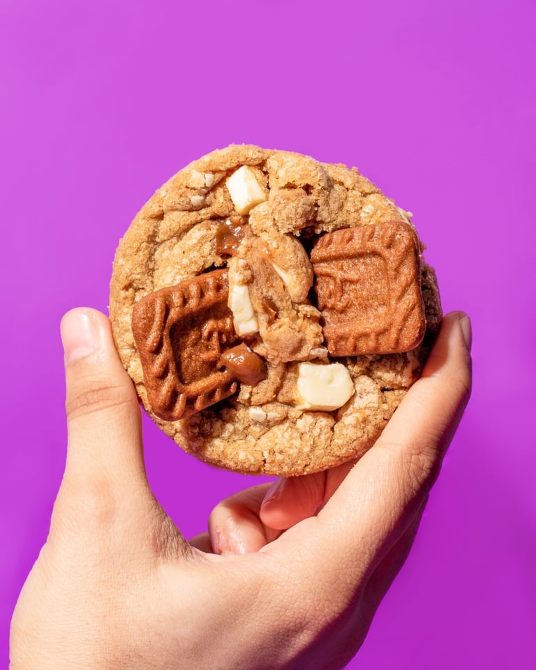 Holding a cookie on a purple background