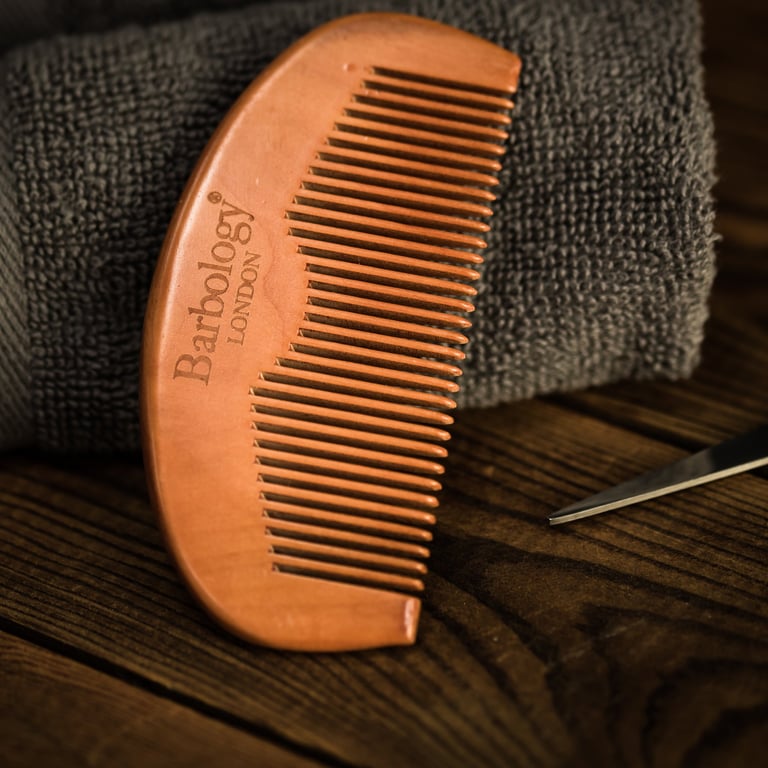 Close up of beard comb sitting on a towel