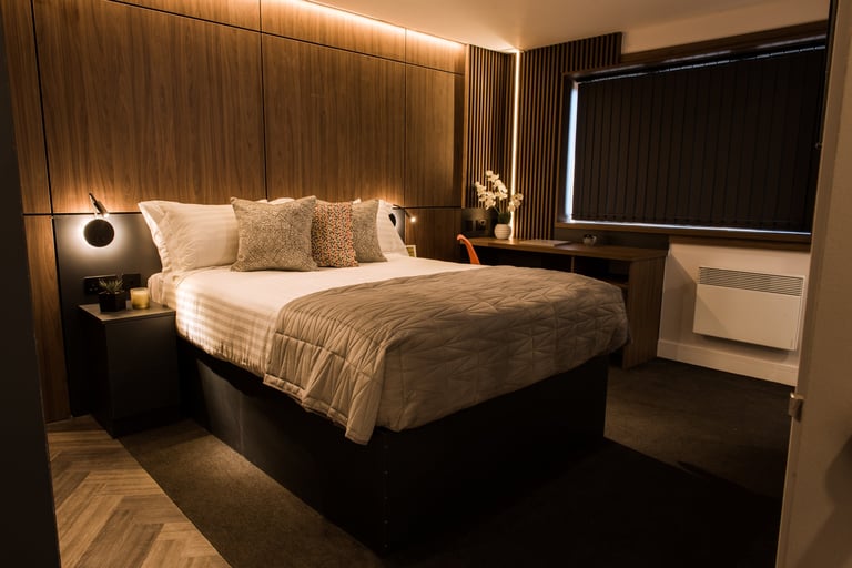 Wide angle view of a studio bedroom with ambient lighting