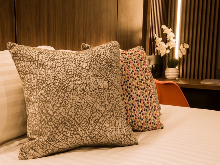 Close up of some decorative pillows on a bed