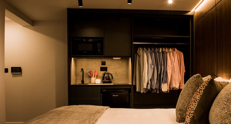 Studio apartment picture showing a bed looking onto the cooking area
