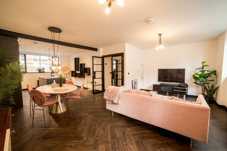 A view of the full room showing the dining area, kitchen and living room