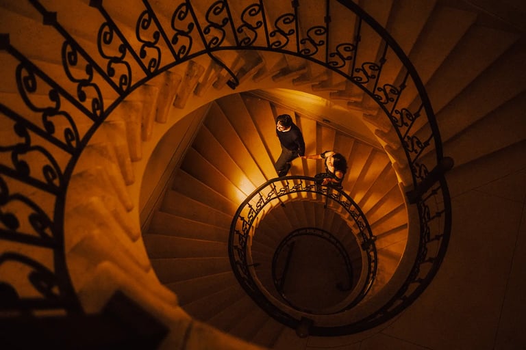 Foto artística de pareja en su sesión de pedida de mano subiendo escaleras elegantes tomados de la mano en Quito Ecuador boda