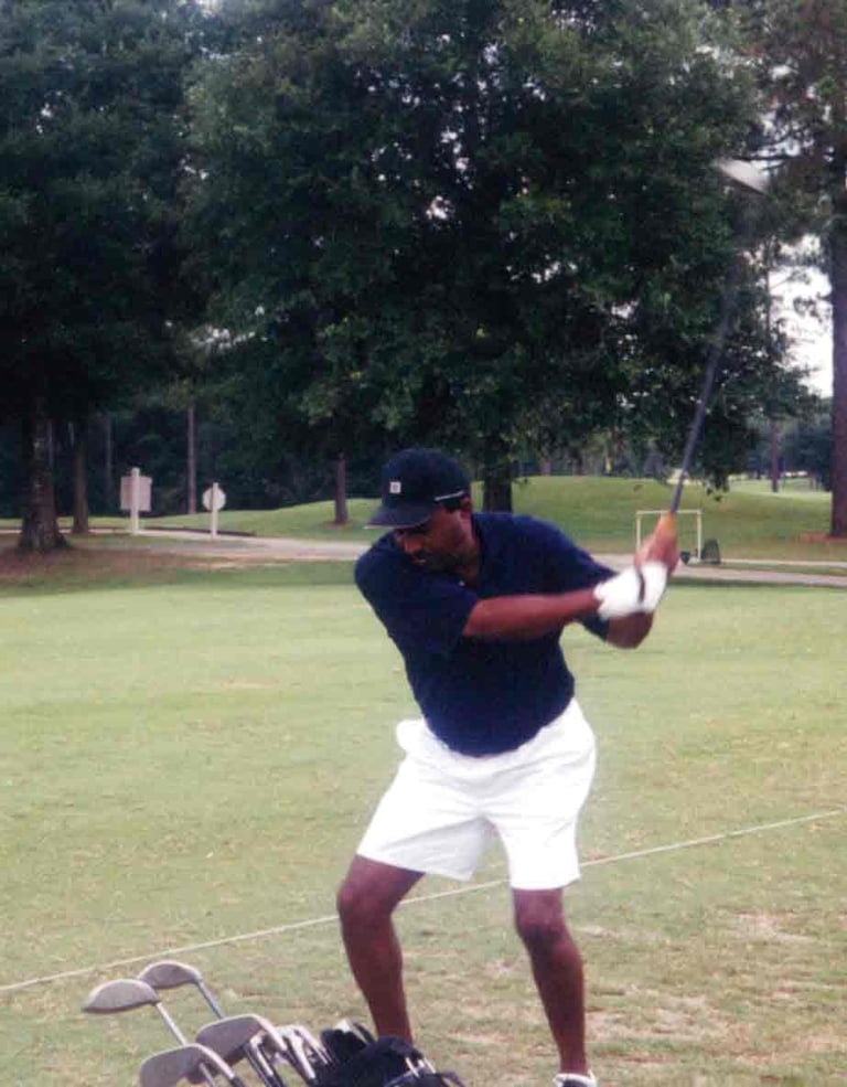 Par Four Golf Club image of black golfer about to hit the golf ball