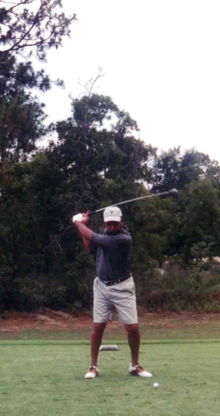Par Four Golf Club image of black golfer about to hit the golf ball