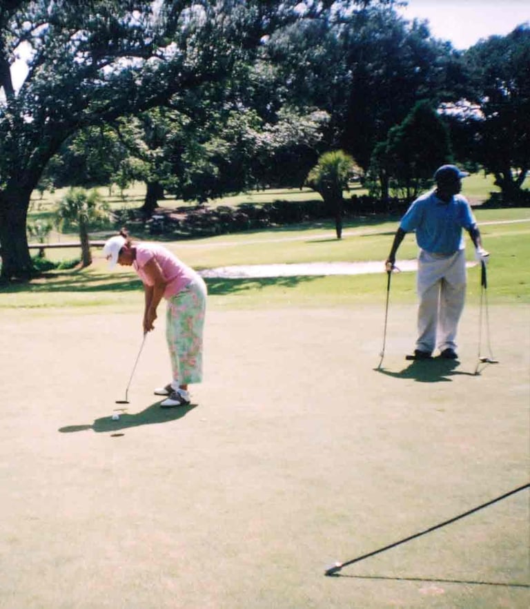 Par Four Golf Club image of female golfer putting the golf ball