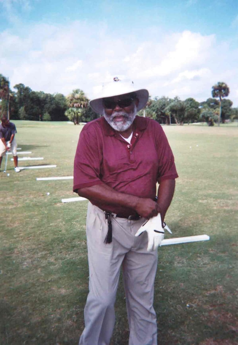 Par Four Golf Club image of a black golfer putting on a golfer glove