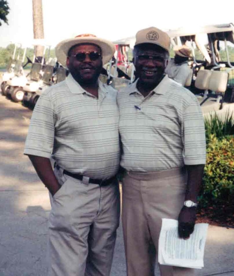 Par Four Golf Club image of two black golfers posing