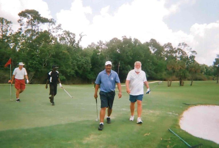 Par Four Golf Club image of four golfers walking on the golf course