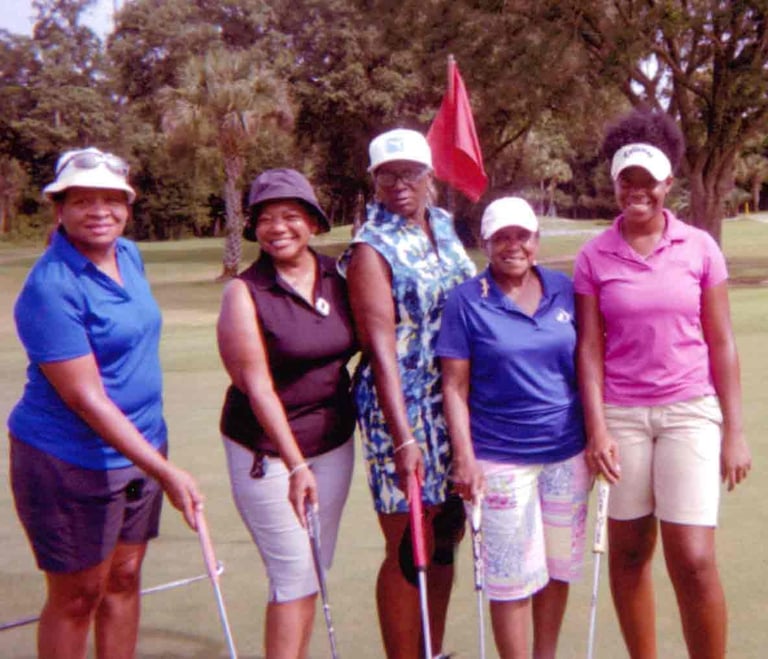 Par Four Golf Club image of four women golfers posing with their golf clubs