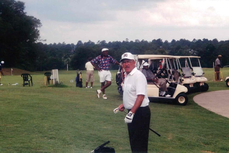 Par Four Golf Club image of black golfer in front of golf carts