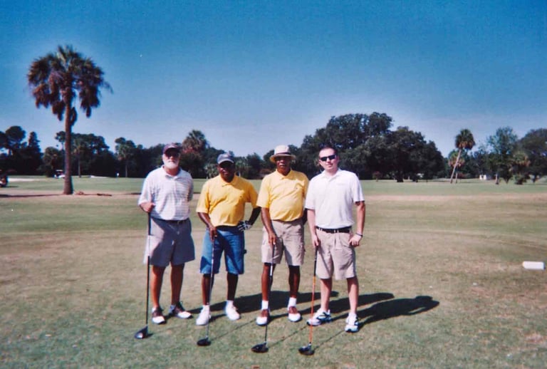 Par Four Golf Club image of four golfers posing with golf club