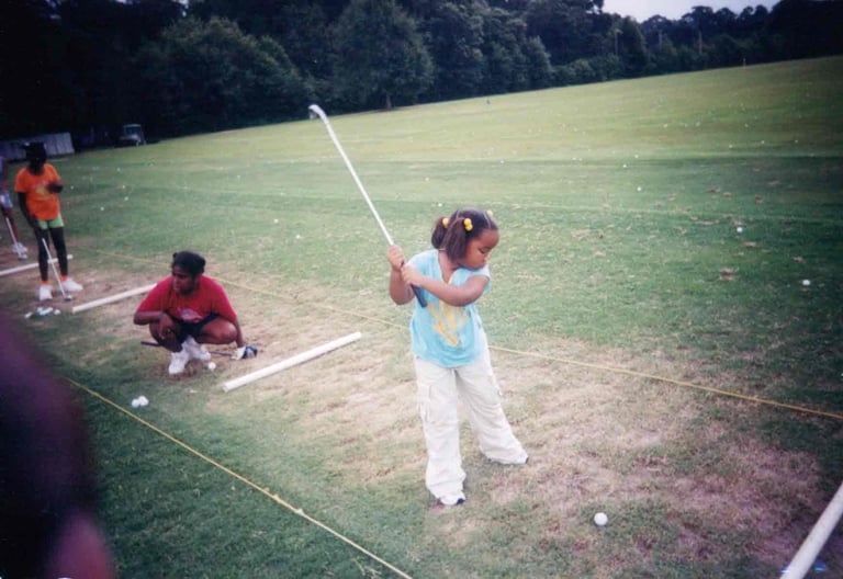 Par Four Golf Club image of young black girl golfer practicing