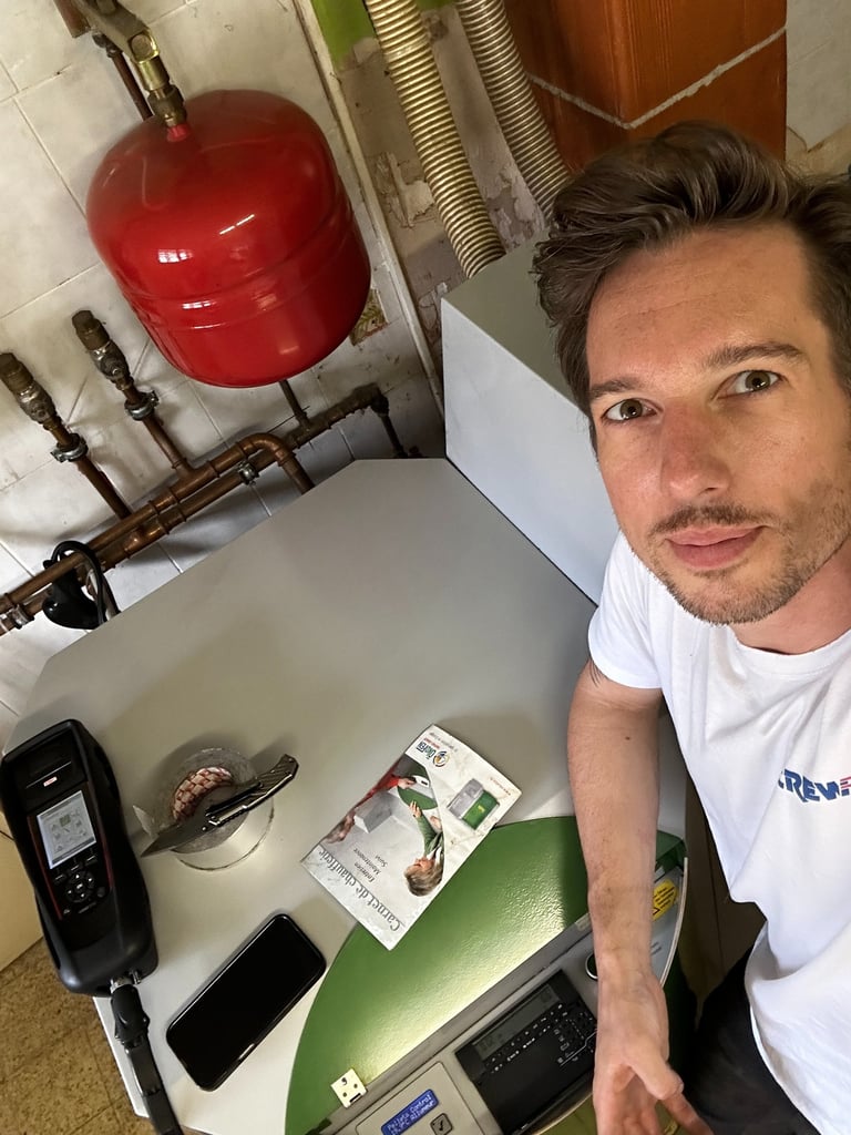 Technician performing a residential boiler service and inspection with a digital analyzer tool.