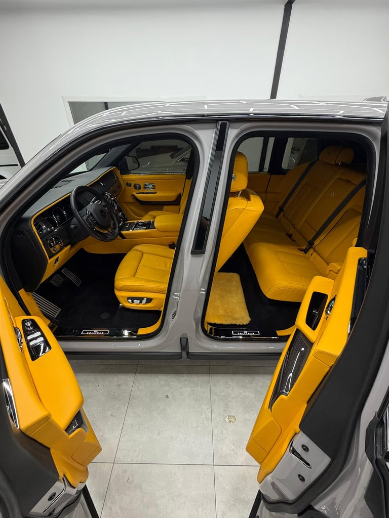Luxury SUV interior with vibrant yellow leather seats and premium cabin features.