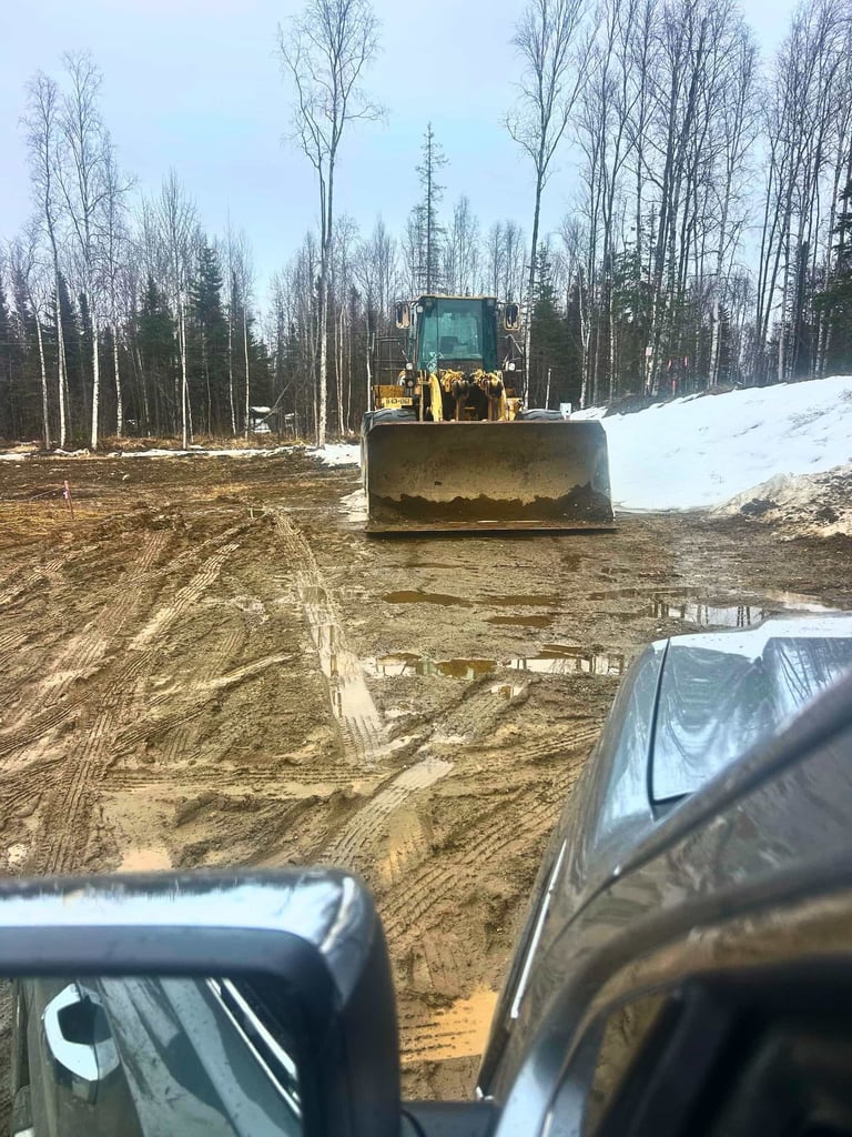 Bucket View Of CAT Frontend Loader On Muddy Jobsite In Houston Alaska
