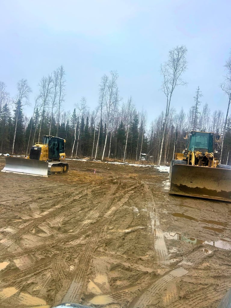 CAT Bulldozer and Frontend Loader Side-By-Side On Muddy Job site In Houston Alaska