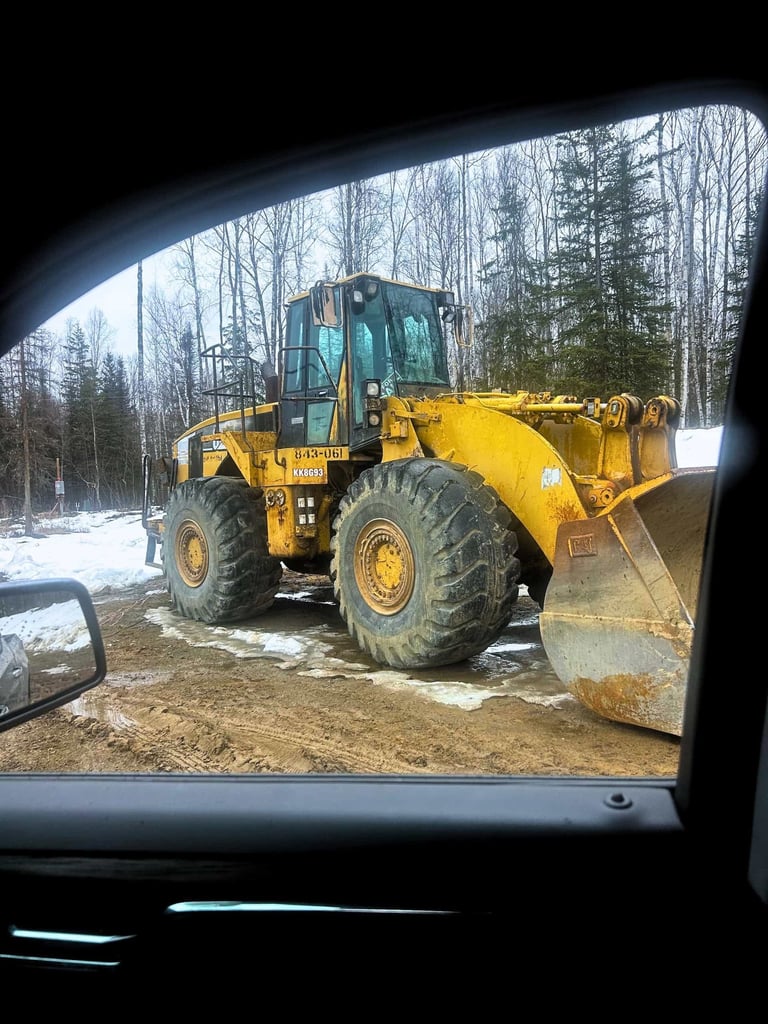CAT Frontend Loader Works on Snowy Job Site In Houston Alaska