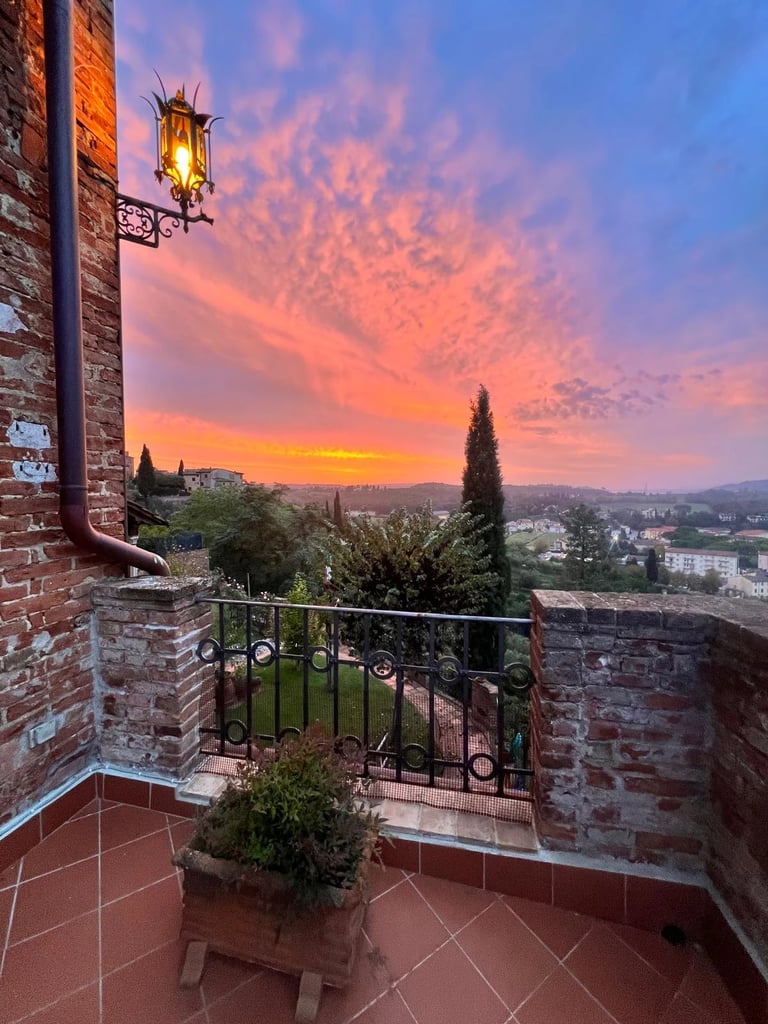 Sunset view over Tuscany from the terrace of an authentic apartment for sale in Certaldo Alto, Italy