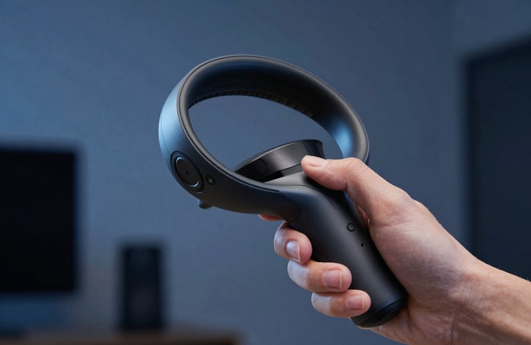 Close-up of a high-tech VR motion controller being held by a user in a dimly lit, blue-tinted room. Professional studio photography, North American / Global context.