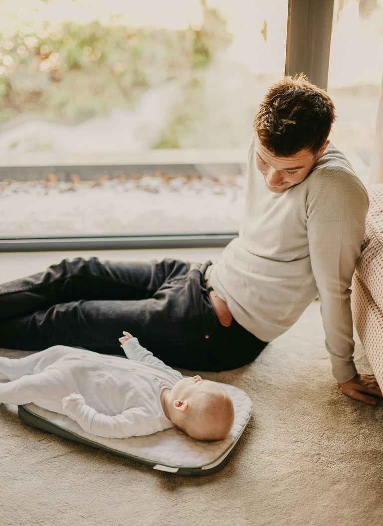 father changing diaper night nursery"
