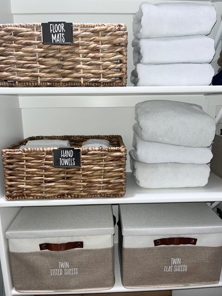 Linen closet organized by professional organizer