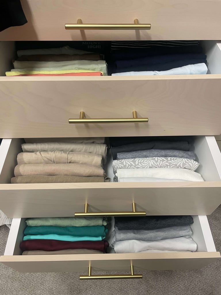 Drawer organization with precisely folded clothing creating a clean and easy to maintain system