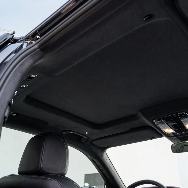 Close-up of a car's leather headrest with stitching.