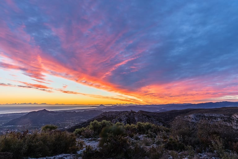 HDR image of the rising sun above the Spanish Costa Valencia with a sleepy mountain village