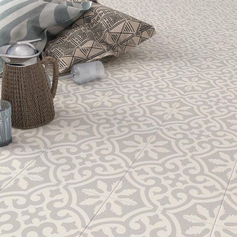 Elegant grey and white patterned ceramic floor tiles with a vintage fleur-de-lis inspired design.