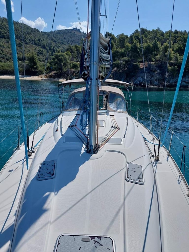 Sail Boat Christina anchored in a crystal-clear bay during a private sailing cruise in Halkidiki