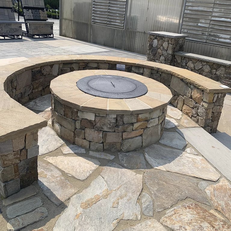 custom stone outdoor fireplace with stone seating area