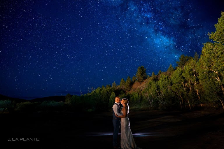 Couple in moonlight with starry sky at wedding retreat