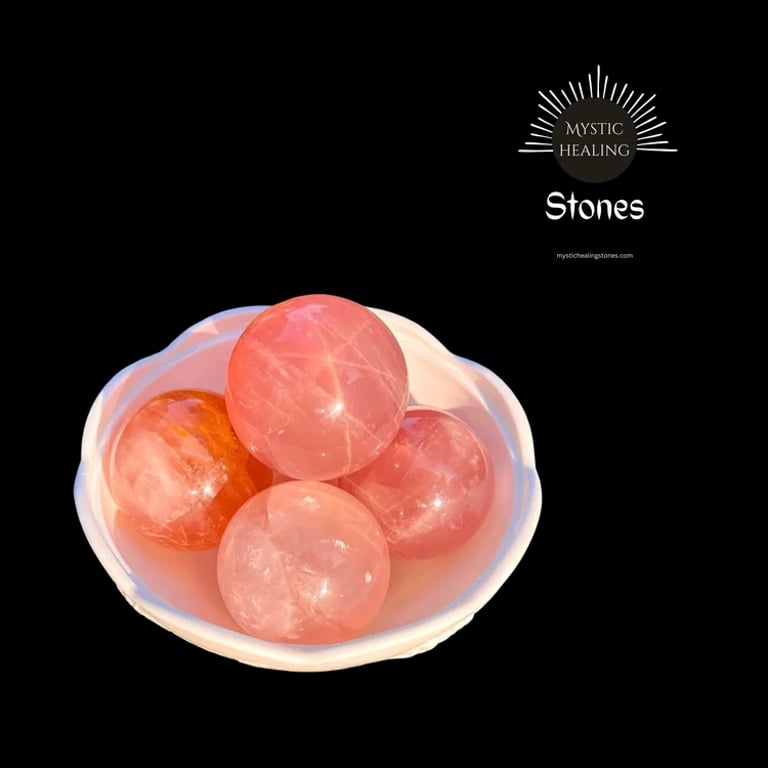 Polished rose quartz crystal spheres displayed in a white bowl for healing and meditation.