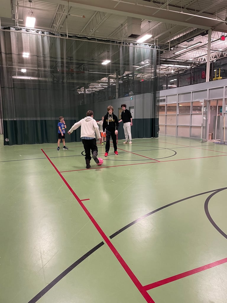 A group of volunteers and children play an soccer game adapted to be inclusive to all children