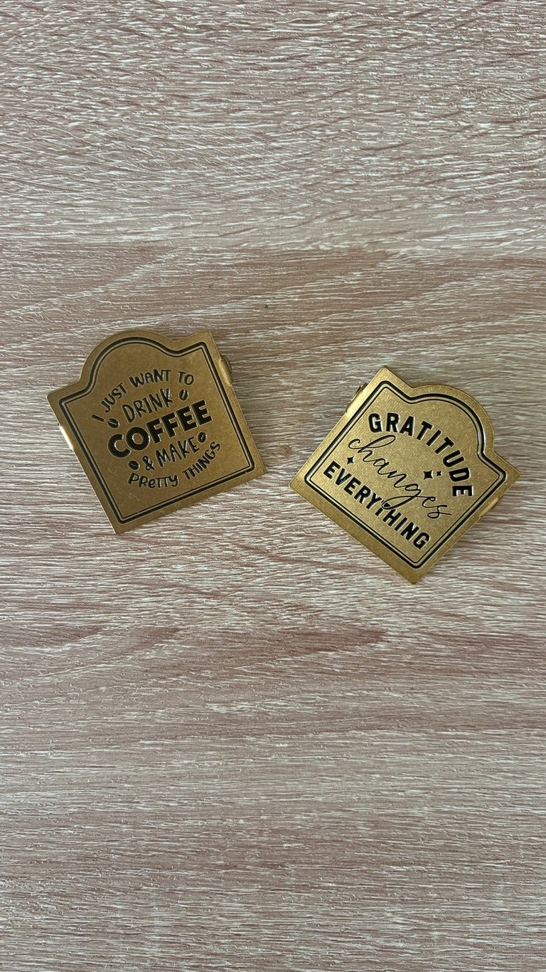 Vintage brass clips holding open a planner for a beautiful journaling aesthetic.