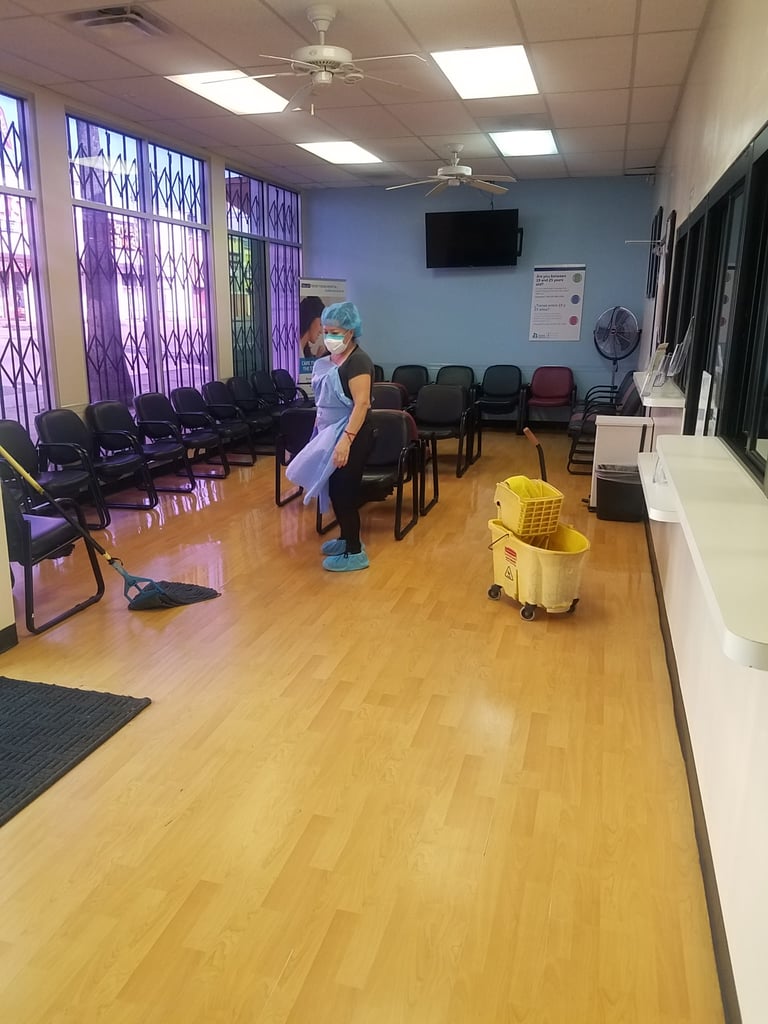 cleaning technician organizing patient waiting room and mopping floor