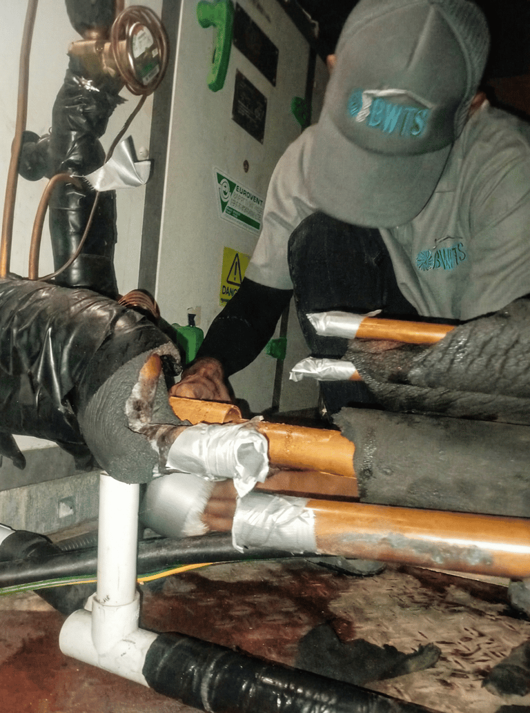BWTS Professional HVAC technician repairing insulated copper piping in Dubai 