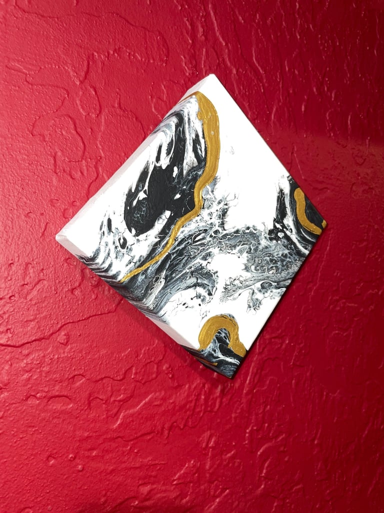 acrylic pour painting on red wall 