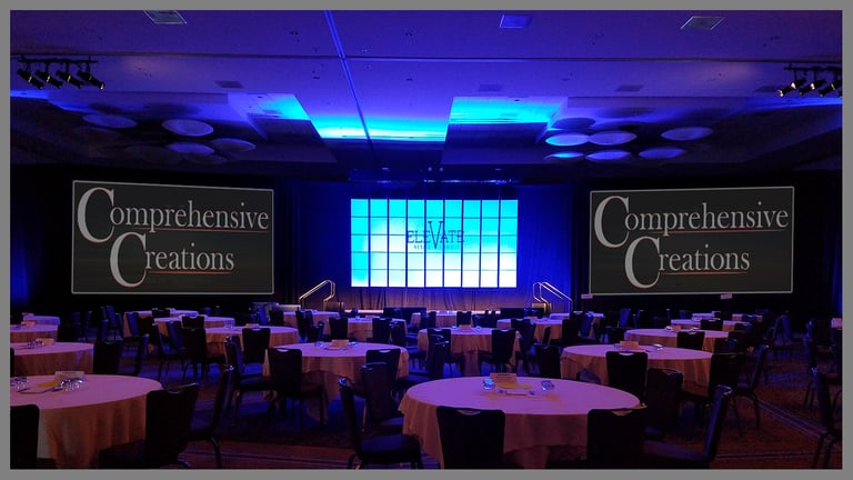 "Elevate" set with center tiles and CC logo on dual screens. Event designed and produced by Comprehensive Creations team.