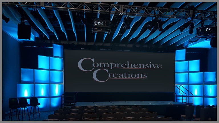 Stepped translucent blocks with blue lighting and CC logo on screen. Event produced by Comprehensive Creations