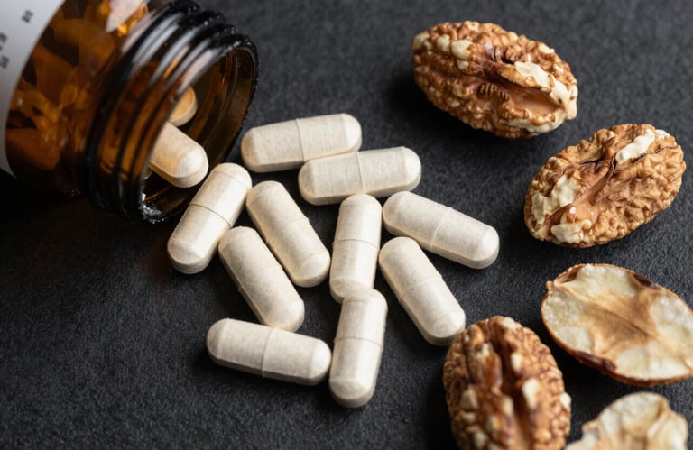 A flat lay of organic supplements and fresh nuts on a black textured surface, accented with gold-toned elements, suggesting luxury and high-performance nutrition.