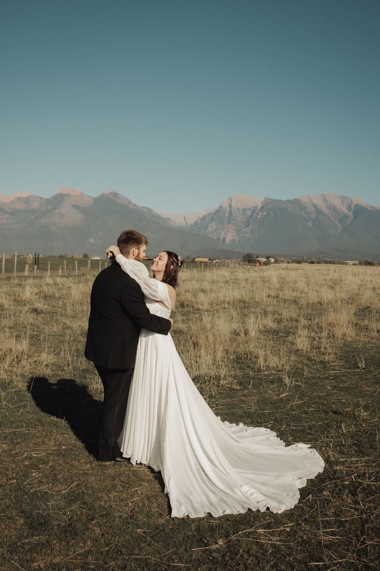 bride and groom portrait in a field, Montana mountains