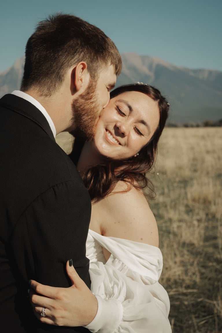 bride and groom portrait, groom kissing bride's cheek
